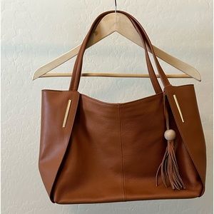 Genuine leather tote w/tassel decoration. Color: brown, dimension 12x8x11
